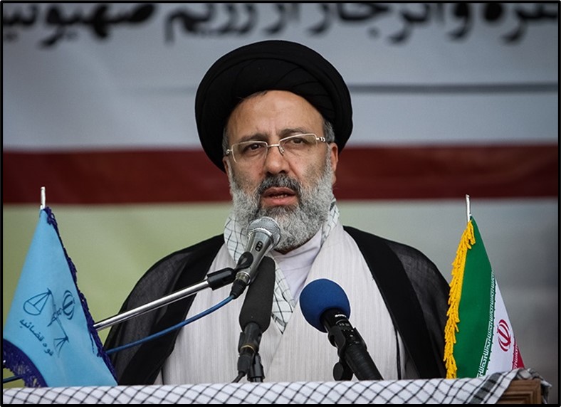 Ebrahim Raisi between flags of Iran's judiciary (left) and the Islamic Republic (right)