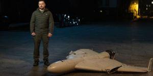 Ukrainian President Zelensky standing next to a downed Iranian drone